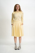 Woman wearing a yellow outfit with a white background